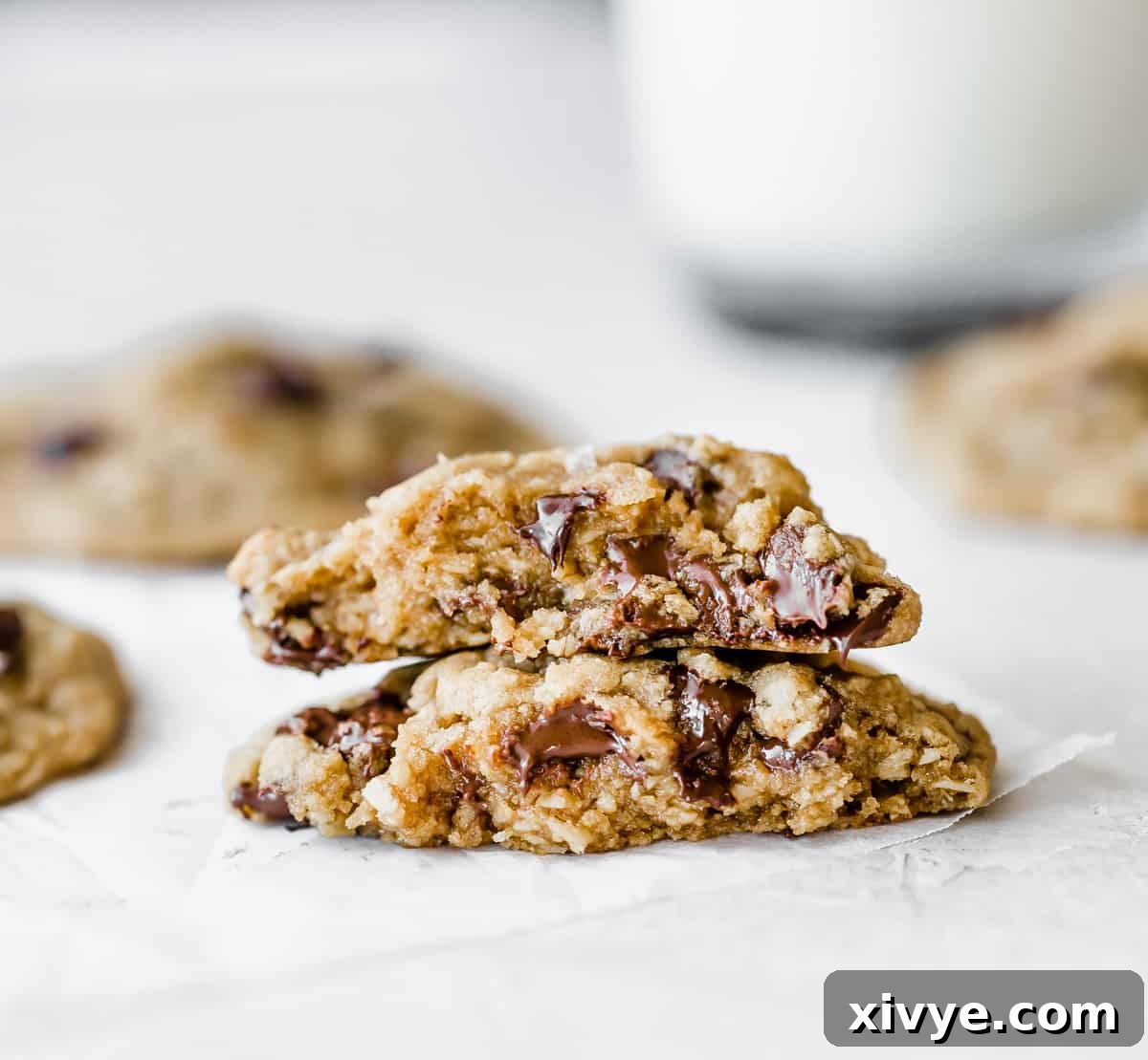 Caramelized Butter Chocolate Chip Cookies 12 A delectable brown butter chocolate chip cookie made with oat flour, artfully split in half and stacked, revealing its tender, chewy interior and molten chocolate chips.