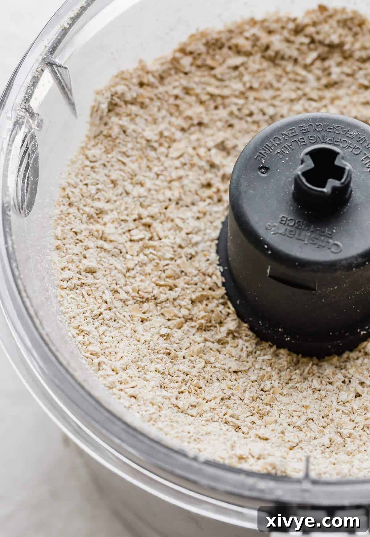 Caramelized Butter Chocolate Chip Cookies 5 Freshly made homemade oat flour in a food processor for making Brown Butter Chocolate Chip Cookies, showcasing its fine texture.