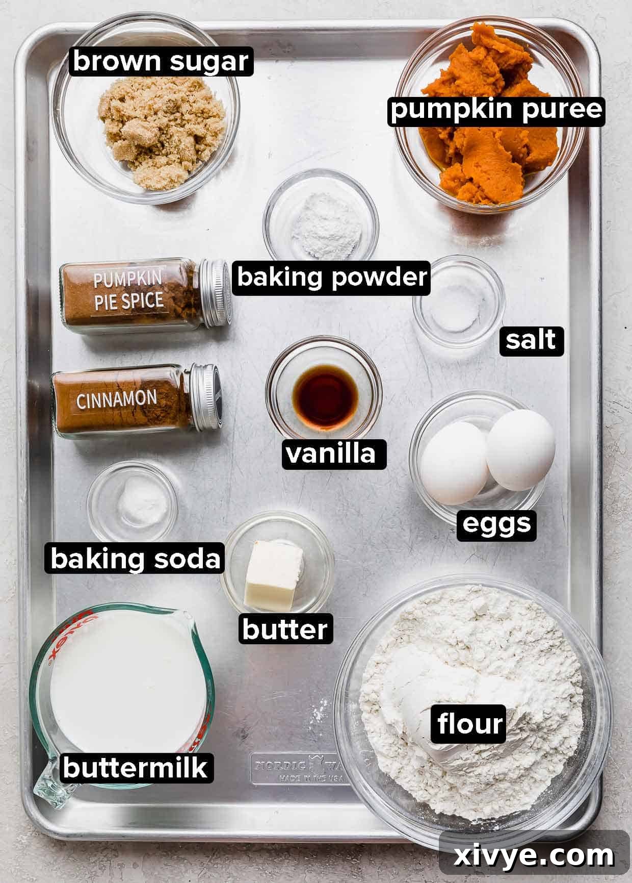 Spiced Pumpkin Pecan Pancakes 3 Pumpkin Pecan Pancake ingredients on a baking sheet, each ingredient in a separate glass bowl. Essential for homemade pumpkin pancakes.