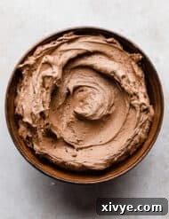 Chocolate Buttercream Frosting Recipe made with melted chocolate in a brown bowl.