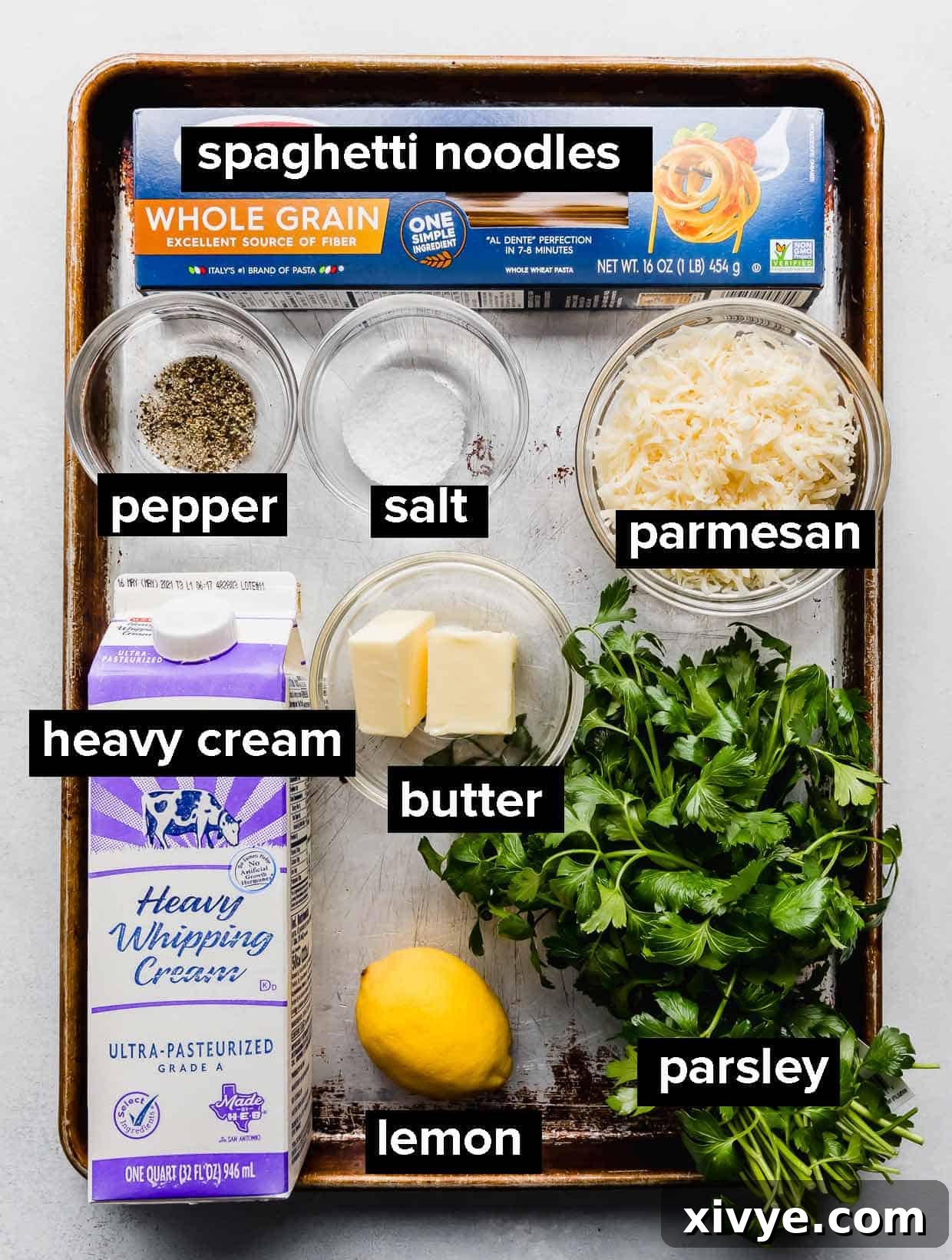 Ingredients used to make lemon pasta on a baking sheet. 