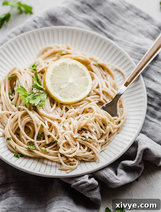 Lemon pasta twirled on a fork.