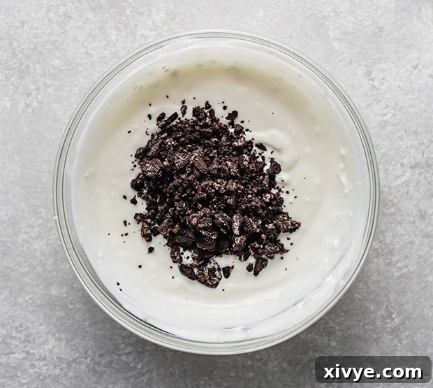 Decadent Cookies and Cream Pops 5 Close-up of a whisk blending the smooth, creamy base mixture for Cookies and Cream popsicles.