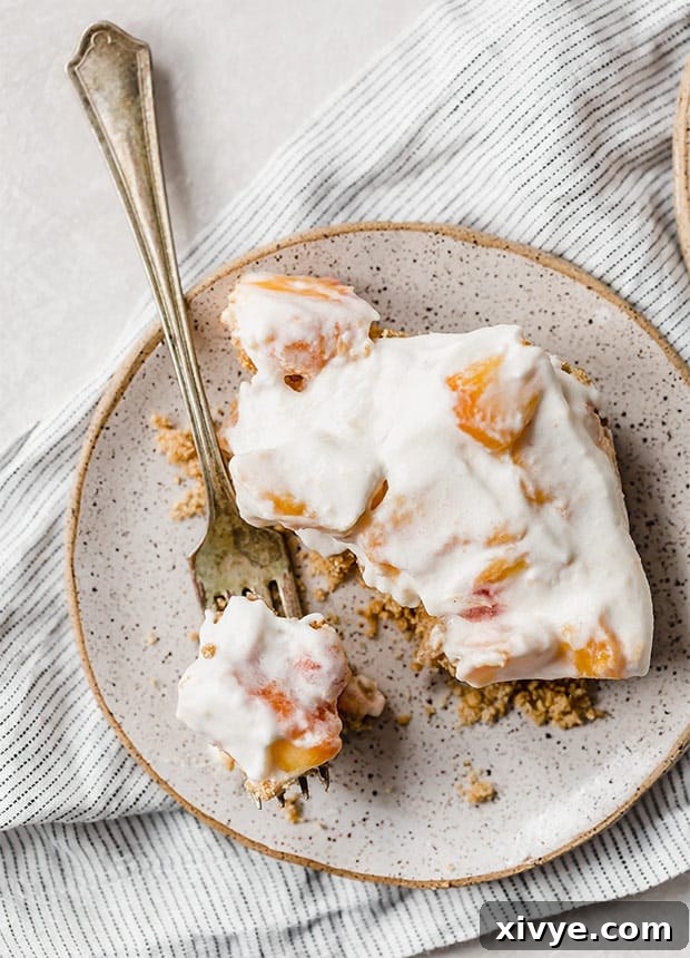 Sun-Kissed Peach Indulgence 2 A plate with a peach dessert recipe and a fork on it, showing the layered texture of crust, peaches, and cream.