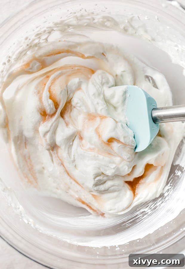 Sun-Kissed Peach Indulgence 4 A bowl of freshly whipped cream mixed with a touch of peach juice, ready to be combined with peaches.