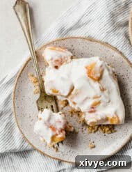 Sun-Kissed Peach Indulgence 8 A plate with a peach dessert recipe and a fork on it.