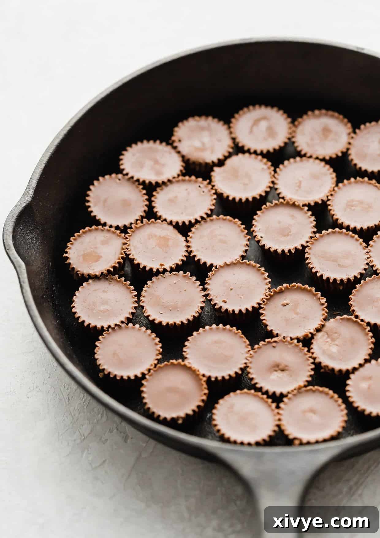 Reese's peanut butter cups in the bottom of a black skillet.