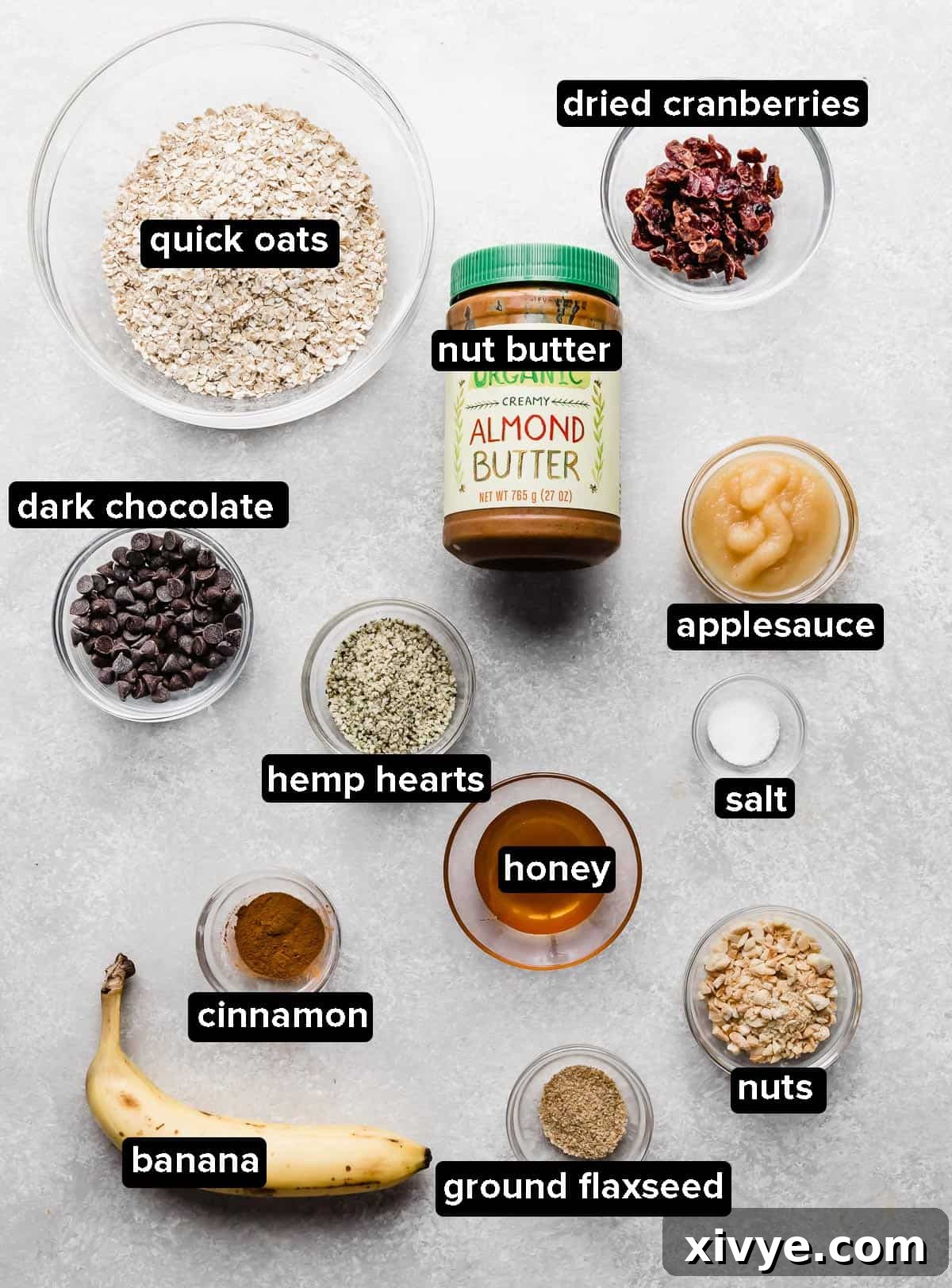 Breakfast Cookies ingredients portioned into glass bowls on a light gray background. 