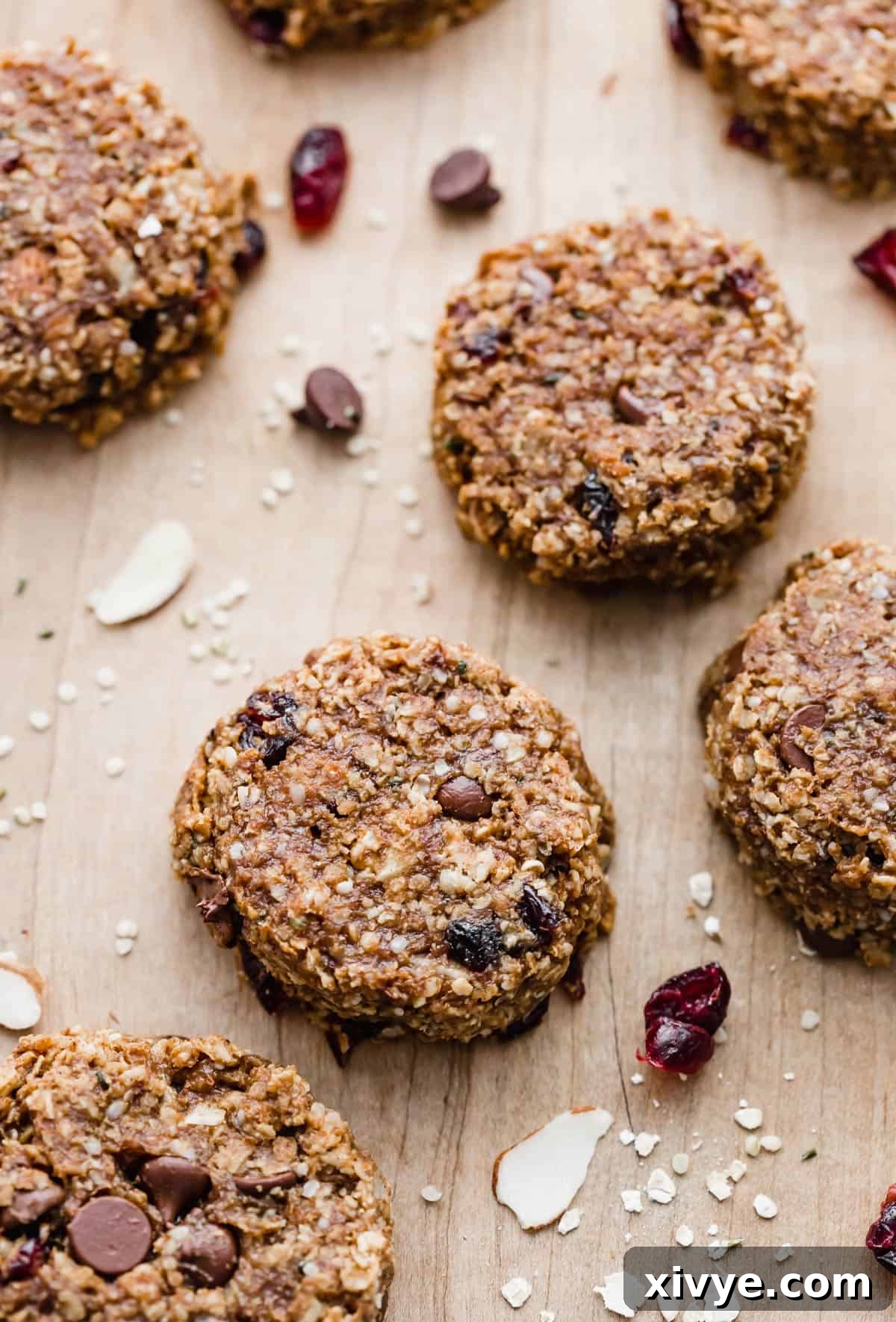 Breakfast Cookies studded with dried cranberries and nuts on a light brown background.