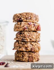 A stack of healthy breakfast cookies on top of each other, against a white background.