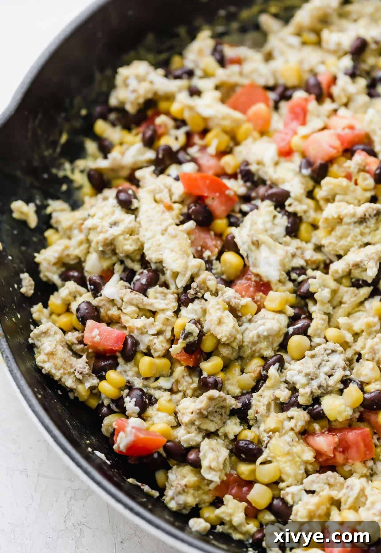 Breakfast Burrito with Black Beans and egg mixture in a cast iron skillet.