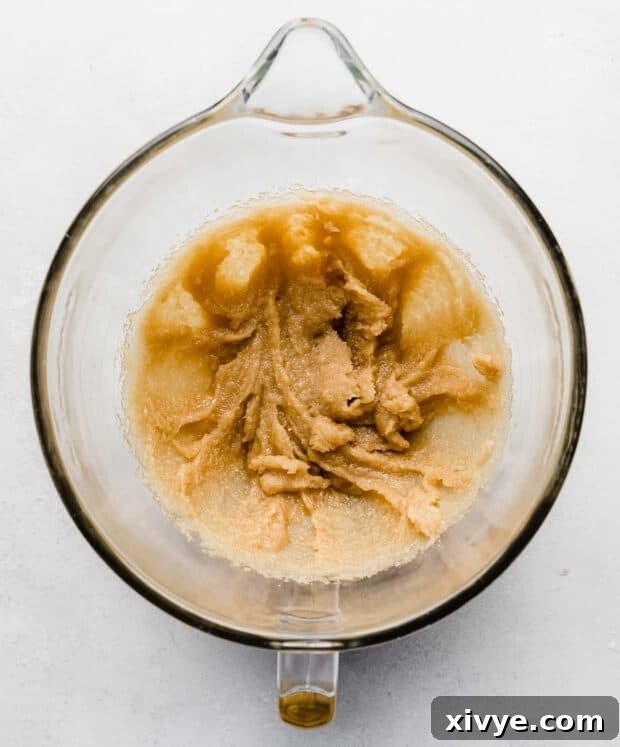 Cosmic Brownie Magic 4 Creamed butter and sugar in a glass mixing bowl, light yellow in color.