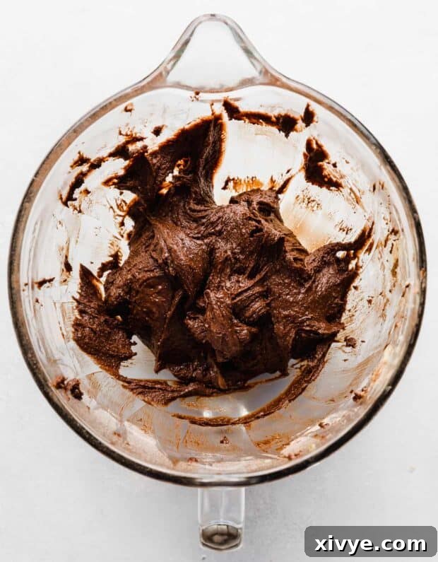 Cosmic Brownie Magic 7 Thick Cosmic Brownie batter in a glass mixing bowl, ready for baking.