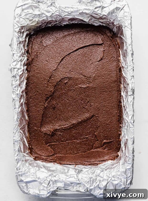 Cosmic Brownie Magic 8 An aluminum foil lined 9x13 baking dish filled with thick Cosmic Brownie batter, leveled evenly.