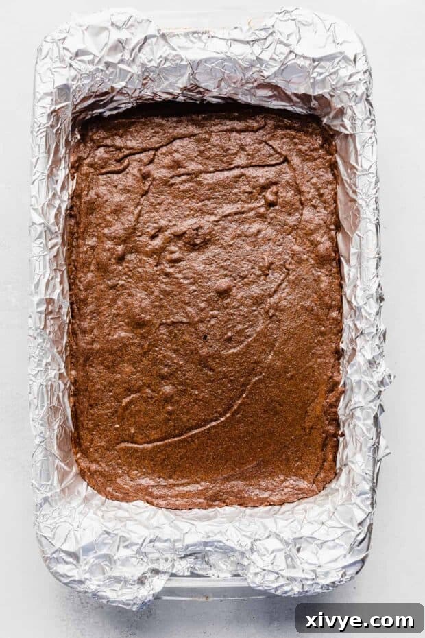 Cosmic Brownie Magic 9 Baked Cosmic Brownies in a foil lined baking dish, golden brown edges and fudgy center.