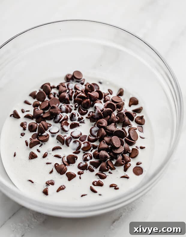 Cosmic Brownie Magic 10 Chocolate chips and heavy cream in a bowl for making ganache, before mixing.