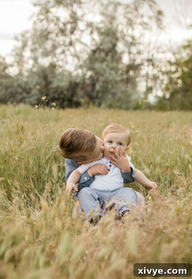 Midweek Treat 3 A young boy gently kissing his baby brother's cheek, a moment of sibling affection.