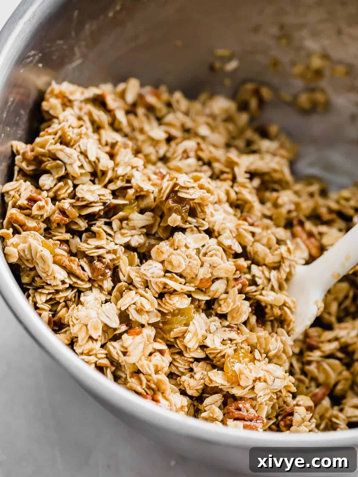 Wholesome Oat & Raisin Granola Bars 6 A silver bowl filled with an Oatmeal Raisin Granola Bars recipe mixture.