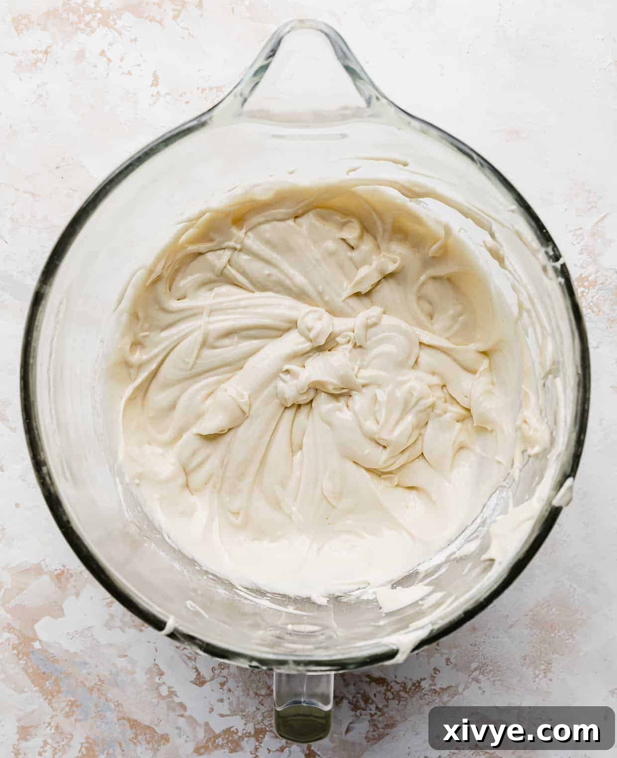 A pristine vanilla cake batter for a smash cake recipe, perfectly mixed and smooth, showcased in a stand mixer bowl.
