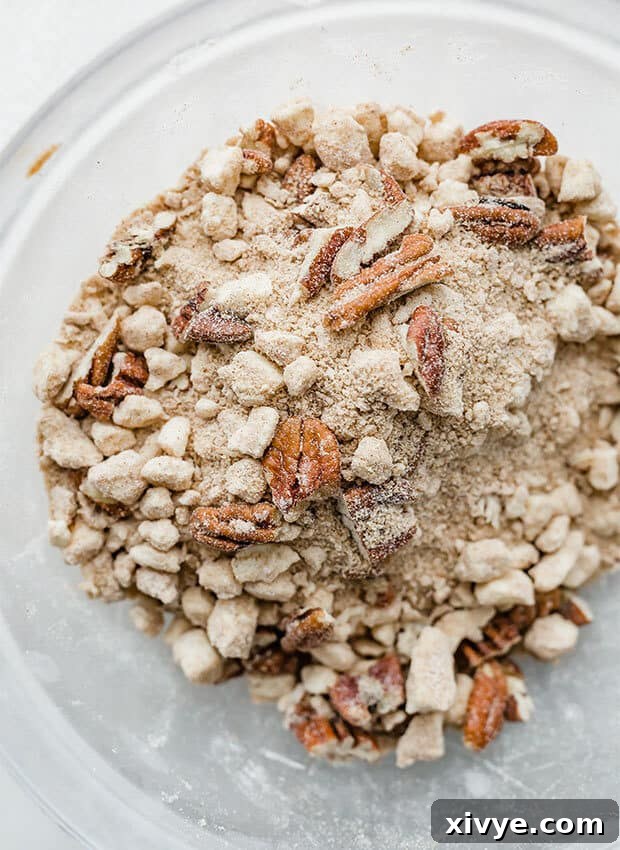 Spiced Pumpkin French Toast Bake 6 A close-up photo showcasing the crunchy texture of the pecan streusel topping for the overnight pumpkin French toast casserole.