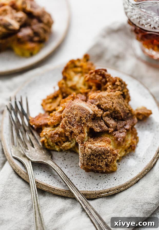 Spiced Pumpkin French Toast Bake 9 Two servings of Overnight Pumpkin French Toast Casserole on a plate with forks, ready to be enjoyed.