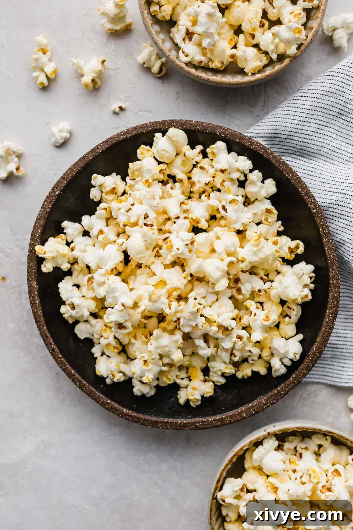 Movie Theater Popcorn made at home, in a sleek black bowl, perfectly set against a clean white background.