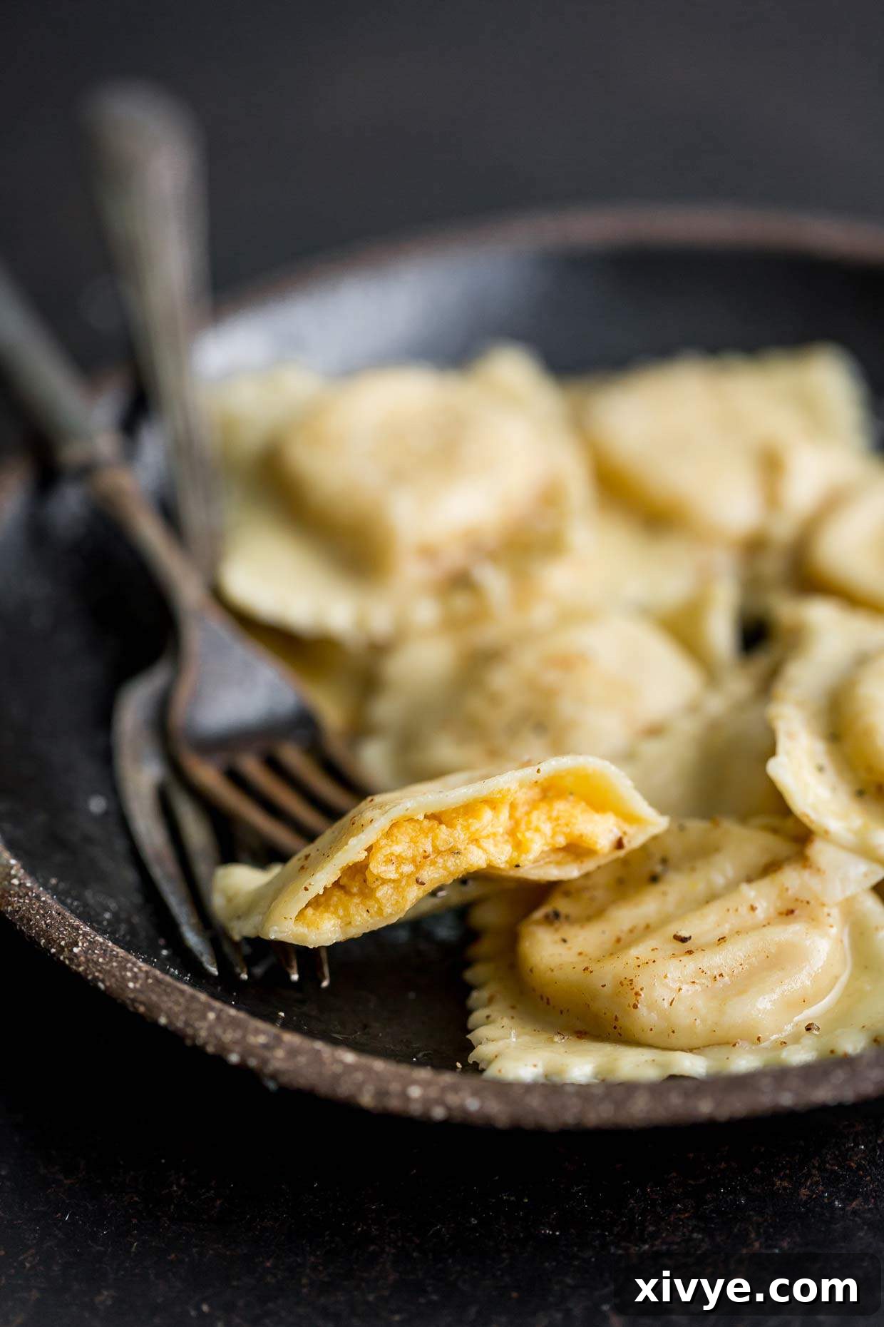 The best Butternut Squash Ravioli cut in half, showing the inside butternut squash filling.