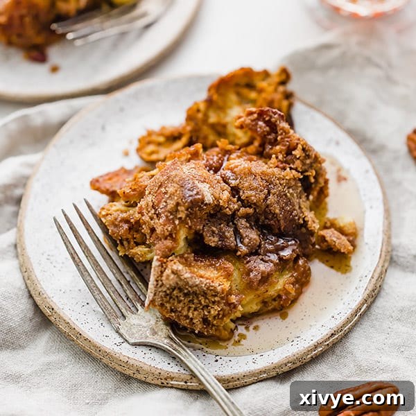 Overnight Pumpkin French Toast Casserole served on a plate, generously covered in rich maple syrup, perfect for a comforting brunch.