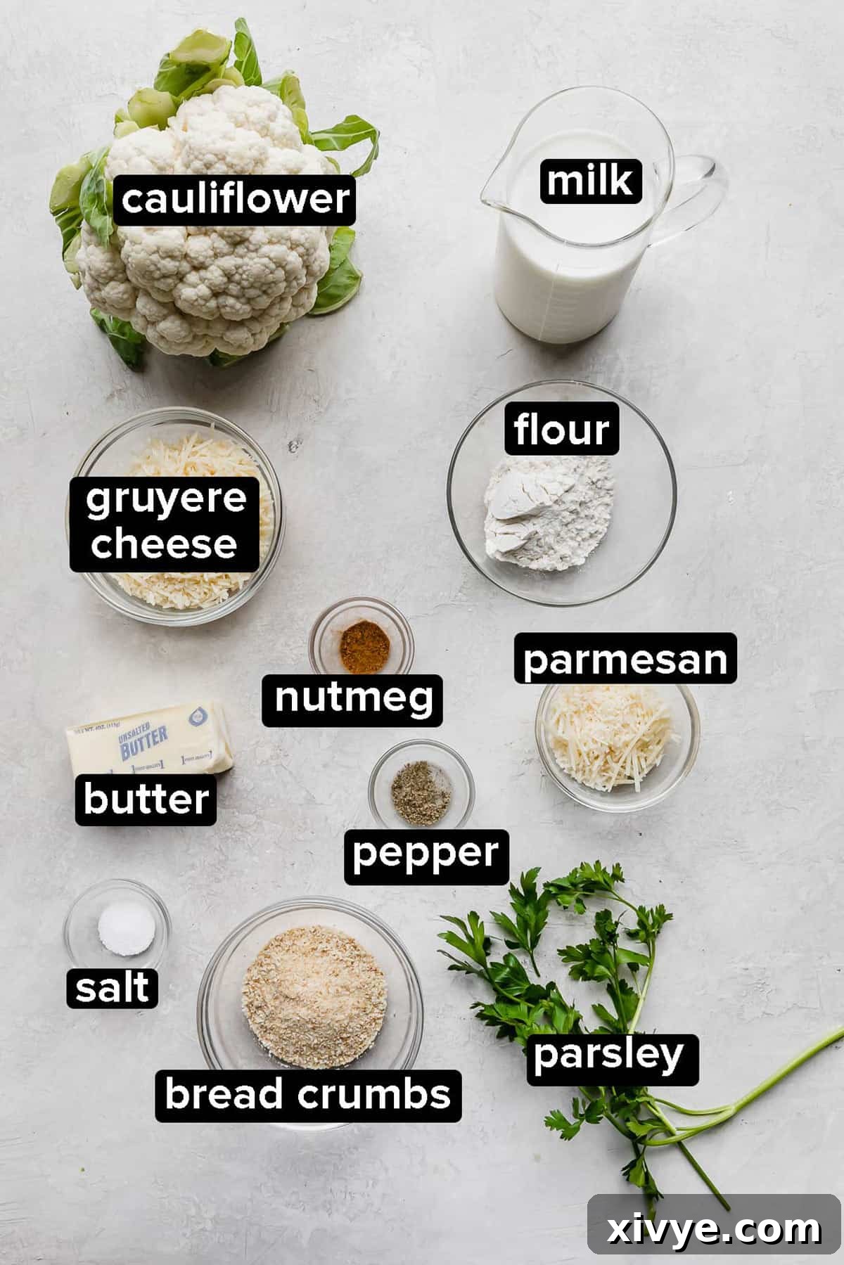 Cauliflower Gratin ingredients on a gray background.