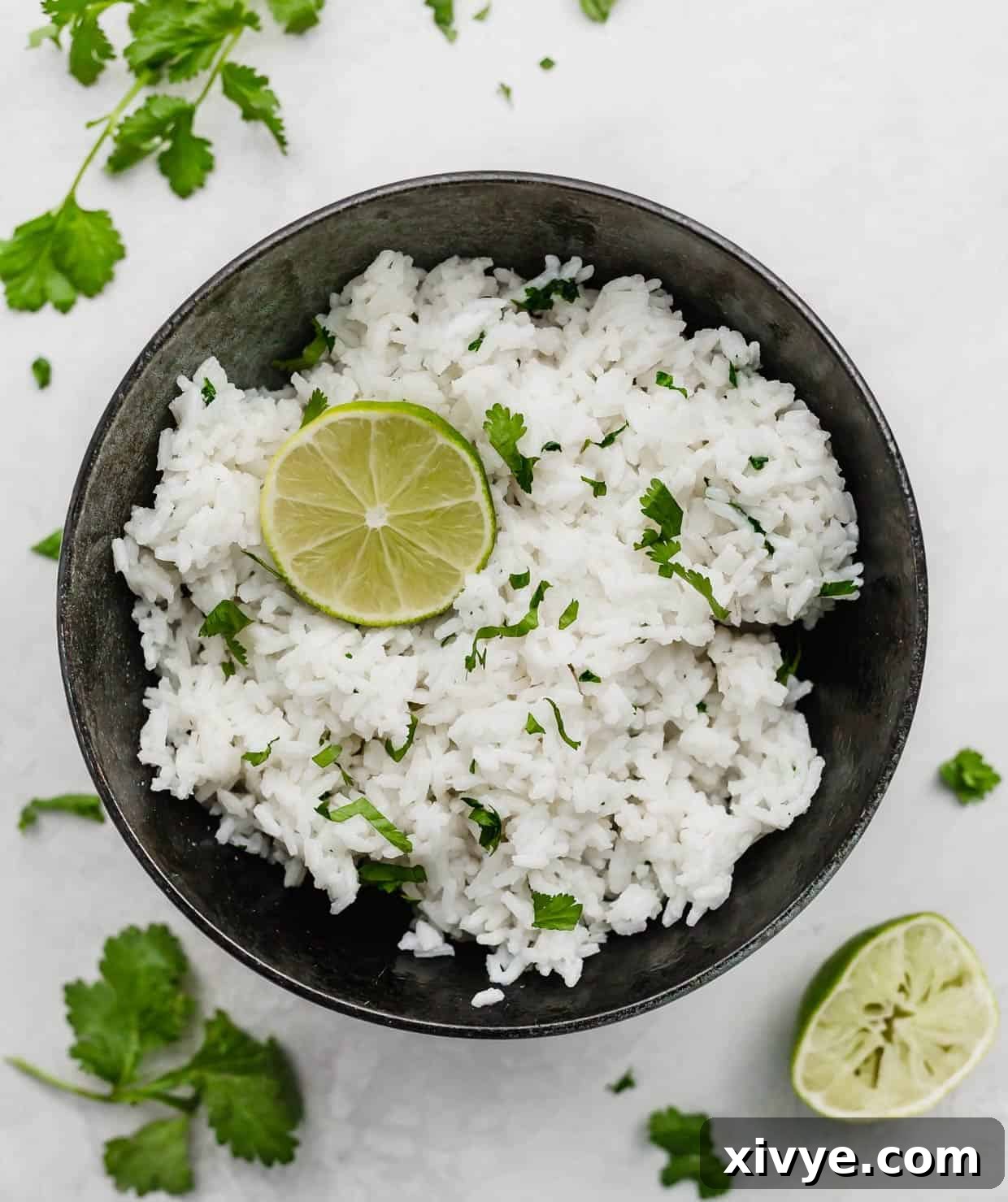 A black bowl with Cilantro Lime Rice in it, on a white background.