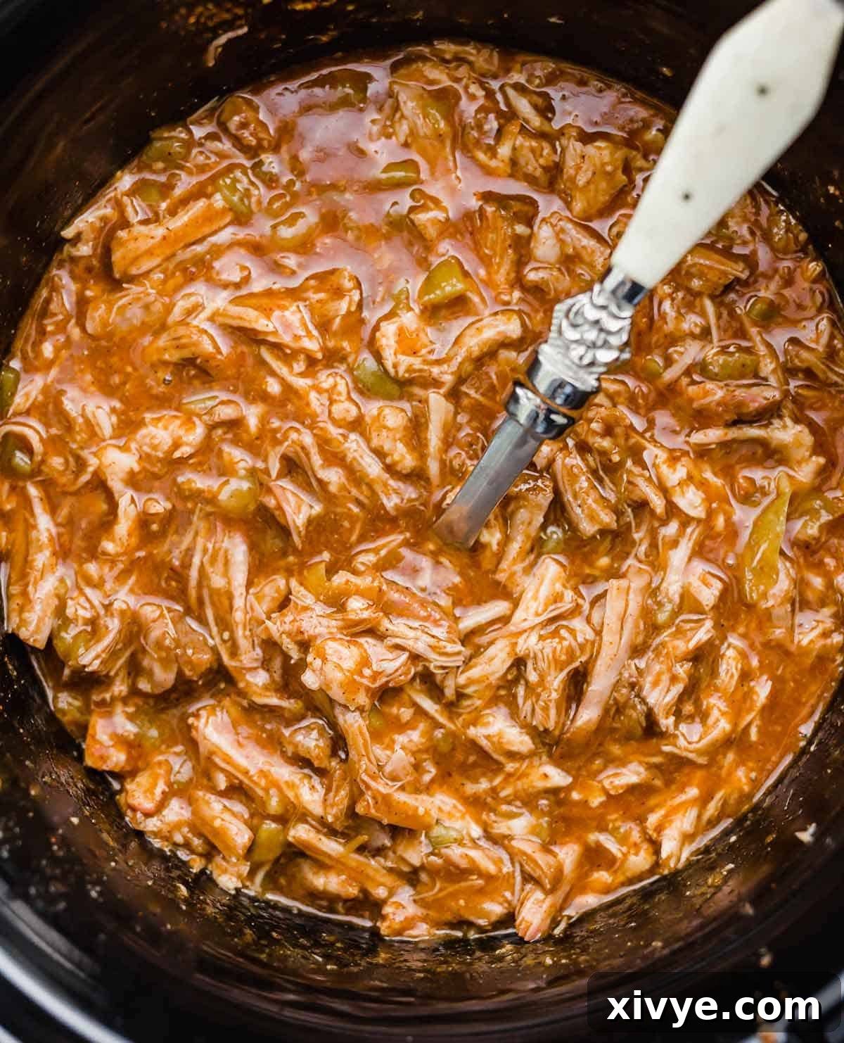 Cafe Rio Sweet Pork Recipe in a black slow cooker, ready to be served.
