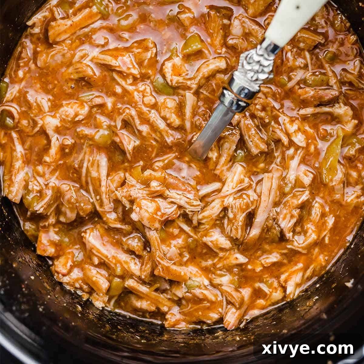 Close up of Cafe Rio Sweet Pork Recipe in a crock pot, garnished with fresh cilantro.