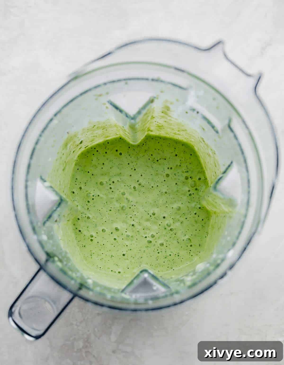 Zesty Cilantro Lime Dressing 5 Vibrant green Cafe Rio Cilantro Lime Dressing in a blender, showcasing its smooth, creamy consistency after blending.