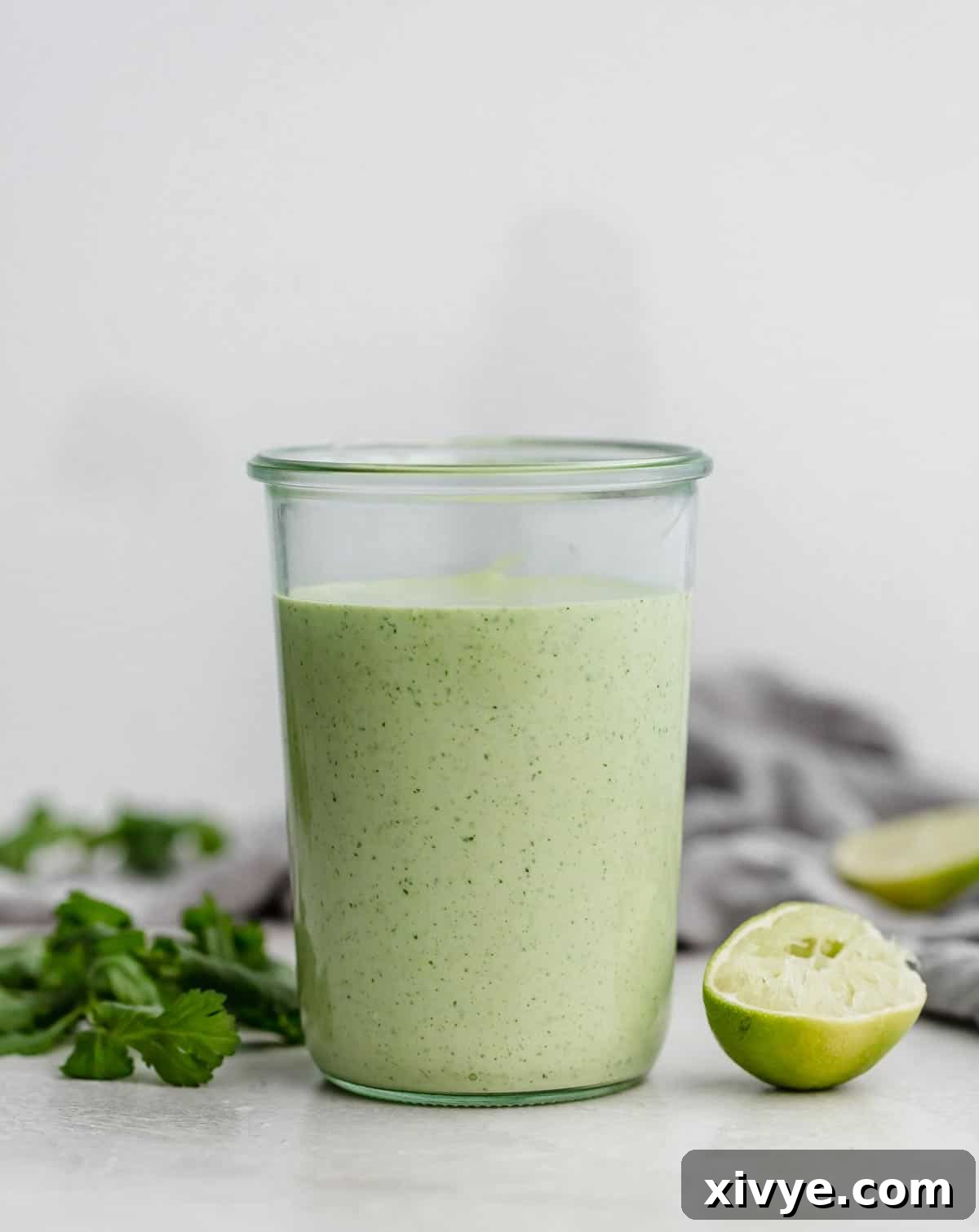 Zesty Cilantro Lime Dressing 6 Cafe Rio Cilantro Lime Dressing in a jar against a light gray background, highlighting its rich color and texture.