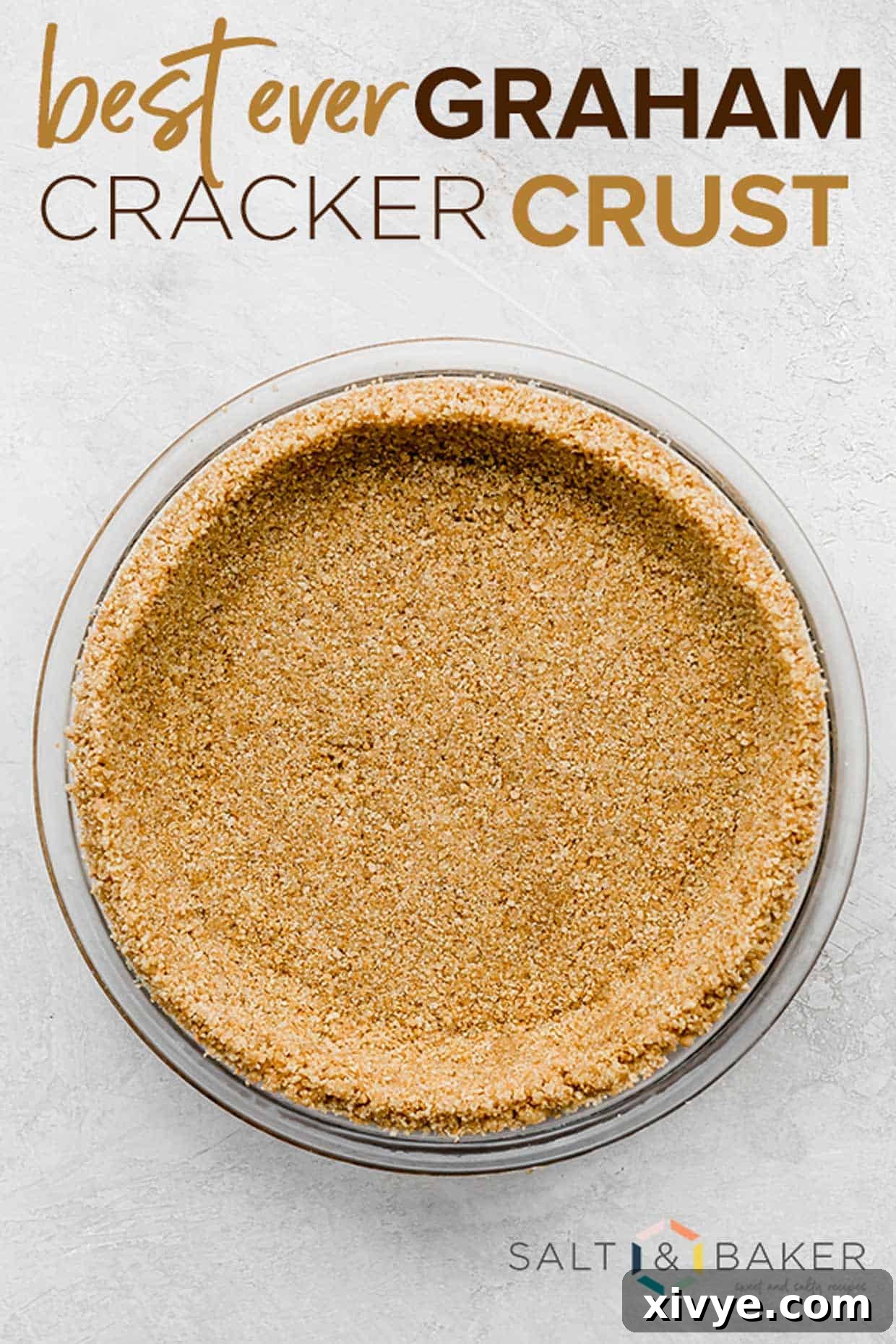 Graham Cracker Crumble Base 2 The best Graham Cracker Crust in a pie plate on a white background with the words, "best ever graham cracker crust" written in brown and tan font over the photo.