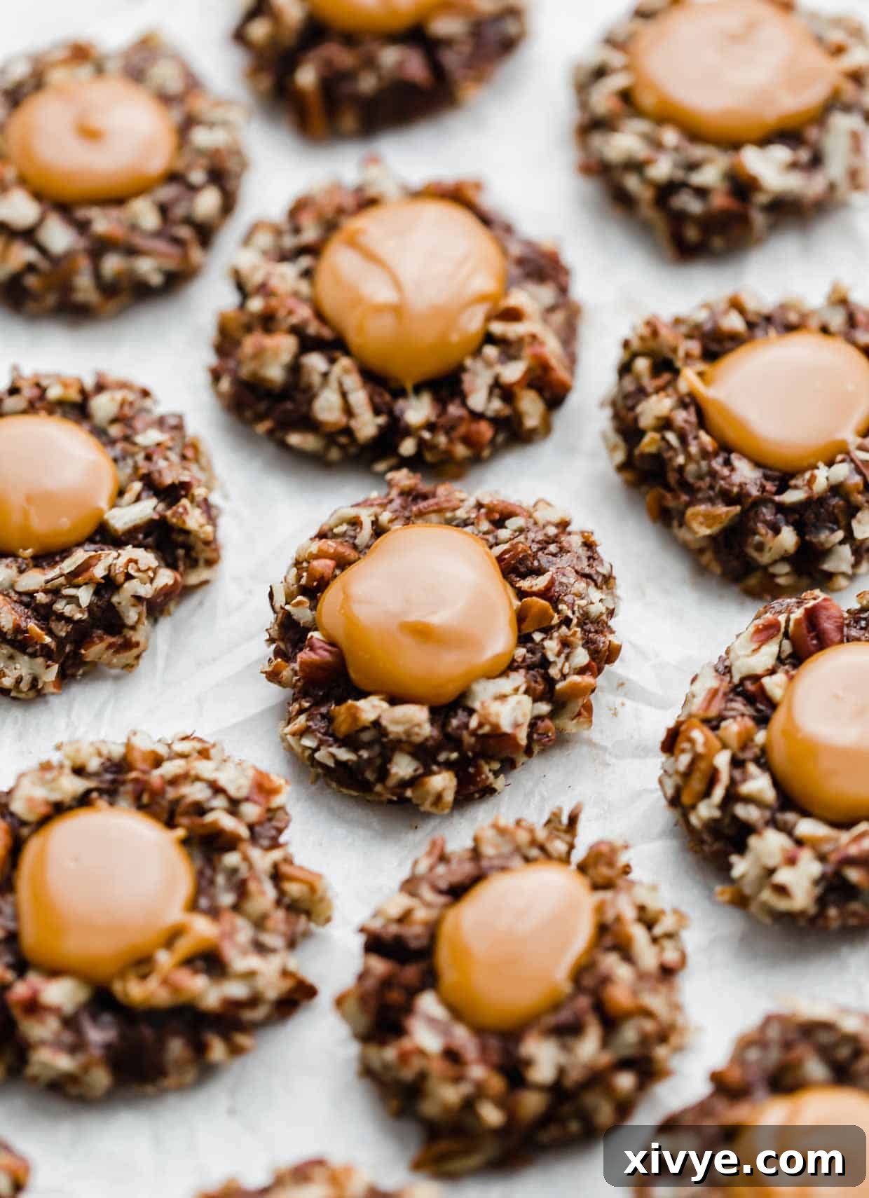Melted caramel in the center of chocolate pecan covered cookies. 