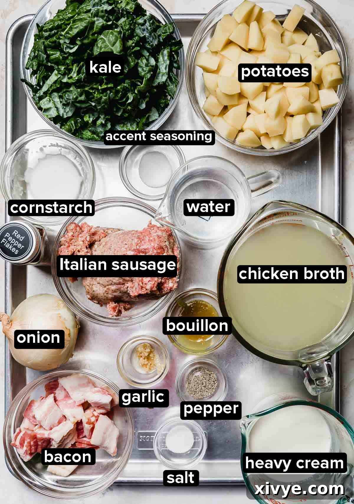 Olive Garden Zuppa Toscana Soup ingredients portioned into glass bowls on a silver baking sheet.