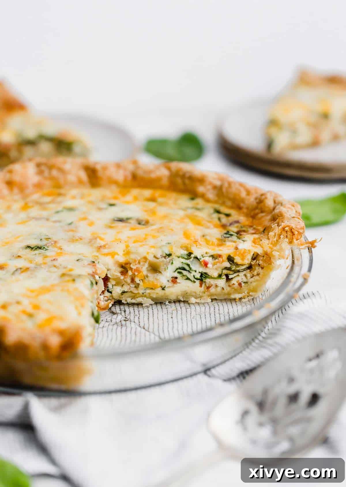 Spinach and Bacon Quiche in a pie plate.