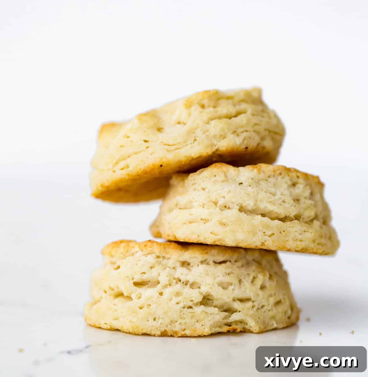 Buttermilk Biscuits, showcasing a stack of golden, fresh-baked treats.
