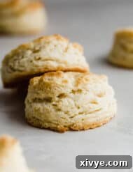 Two easy buttermilk biscuits on a gray background.