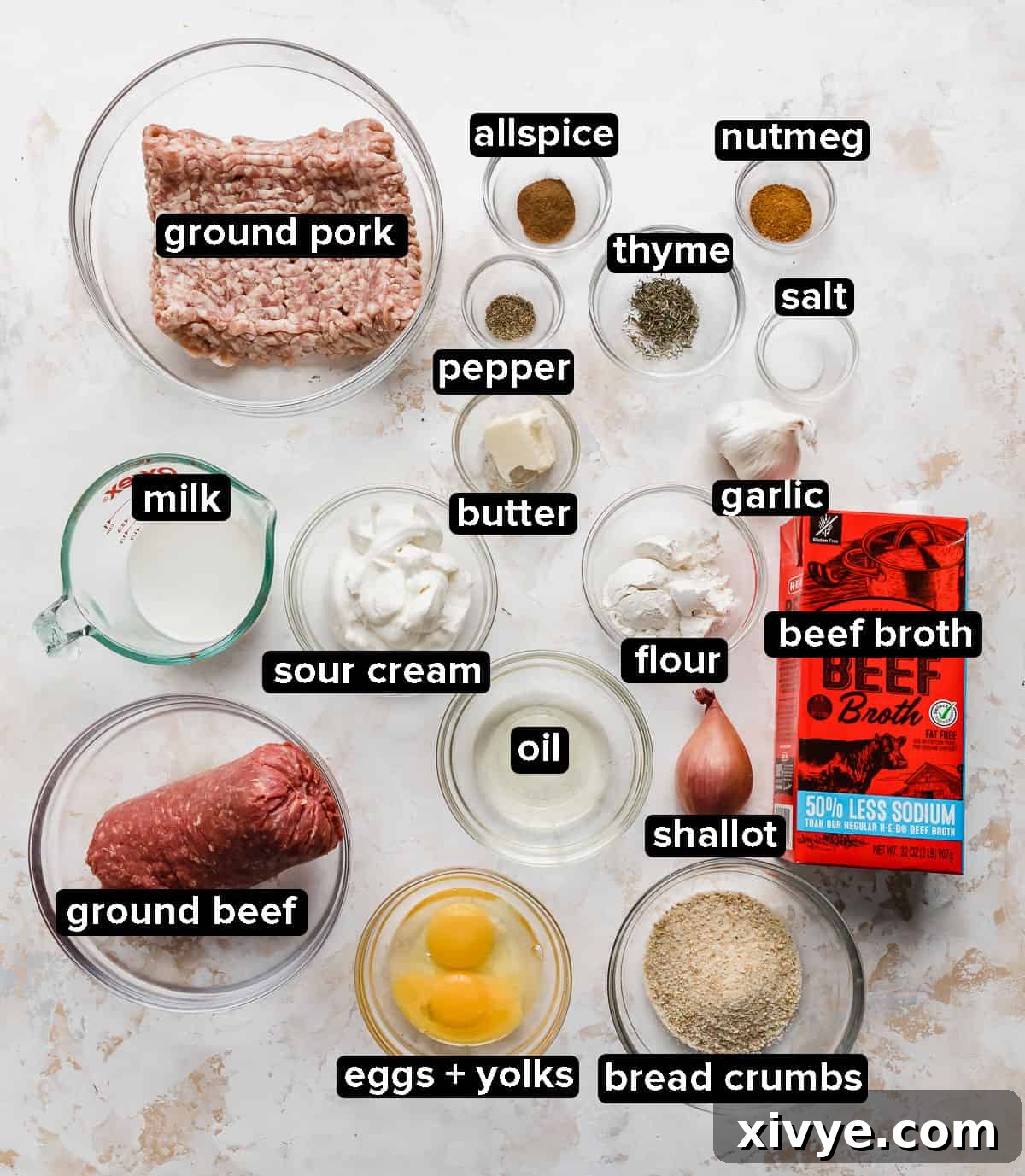 Swedish Meatballs ingredients in glass bowls on a white textured background.