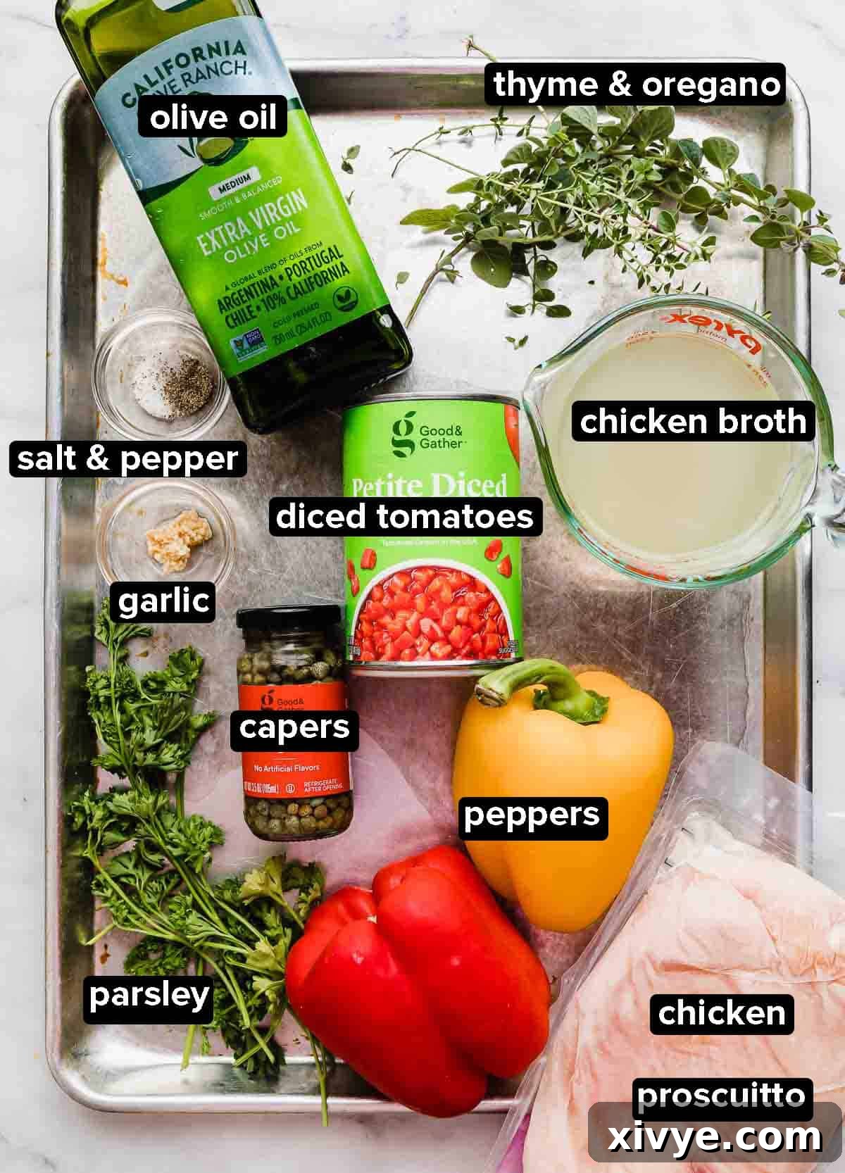 Imperial Chicken 3 Roman Chicken ingredients on a silver baking sheet: capers, chicken, olive oil, peppers, fresh herbs, canned tomatoes, prosciutto.