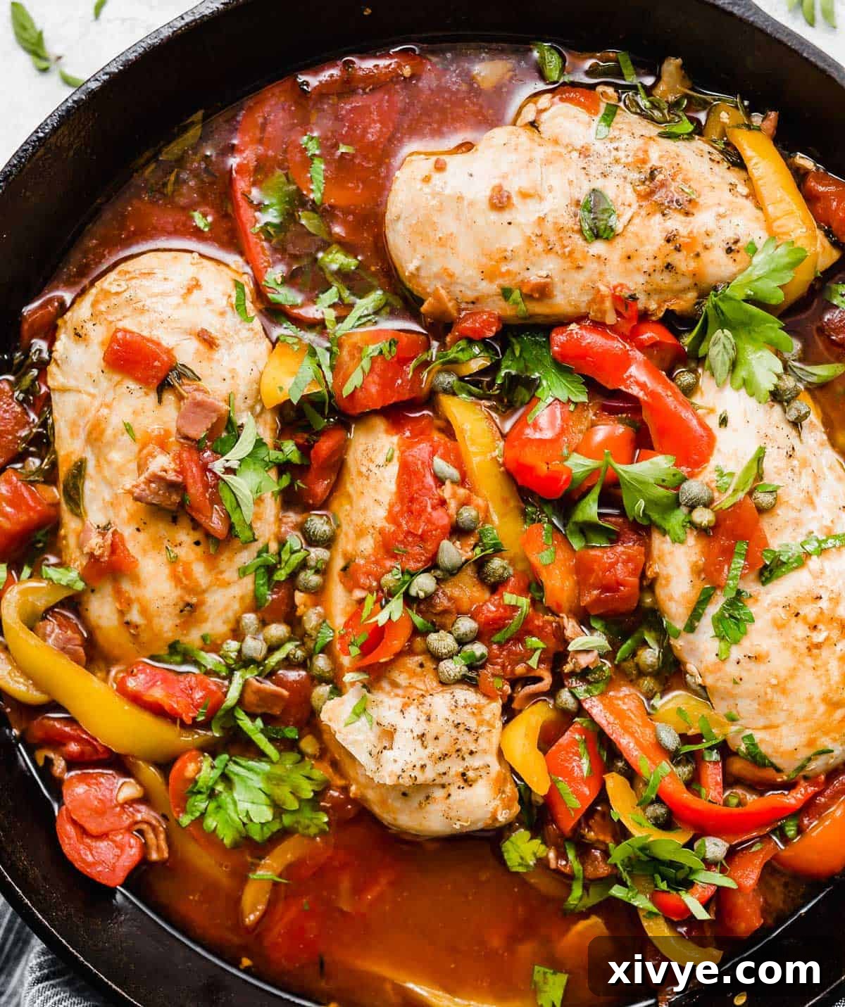 Imperial Chicken 6 Overhead photo of Roman style chicken in a red sauce in a skillet.