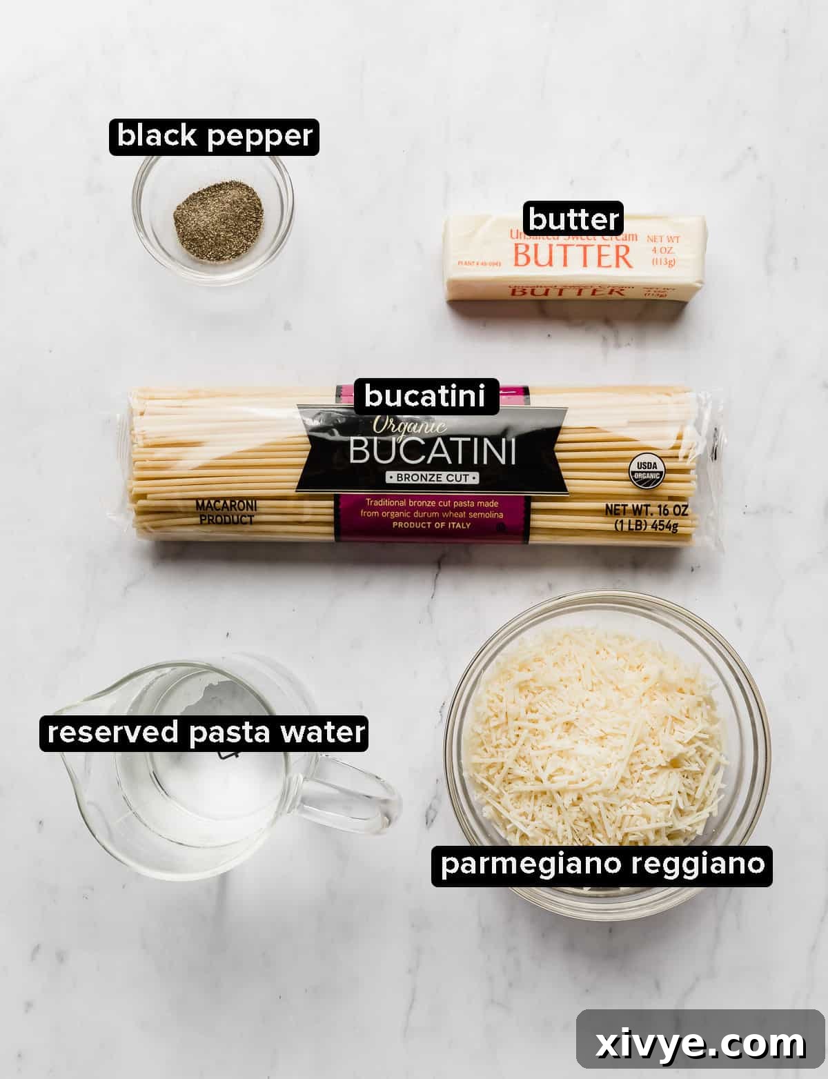The Ultimate Bucatini Cacio e Pepe 3 Bucatini Cacio e Pepe ingredients laying on a white background.