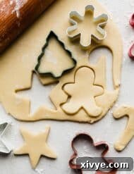 Rolled out sugar cookie dough on a white background.