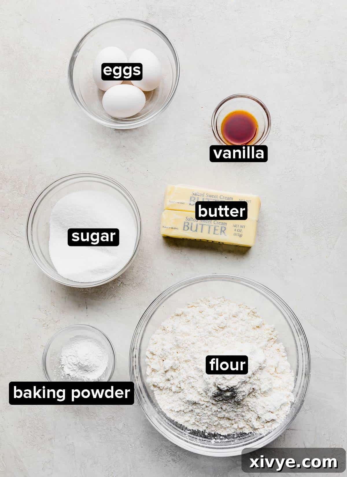 Ingredients used to make No Fail Sugar Cookies, on a gray background. 