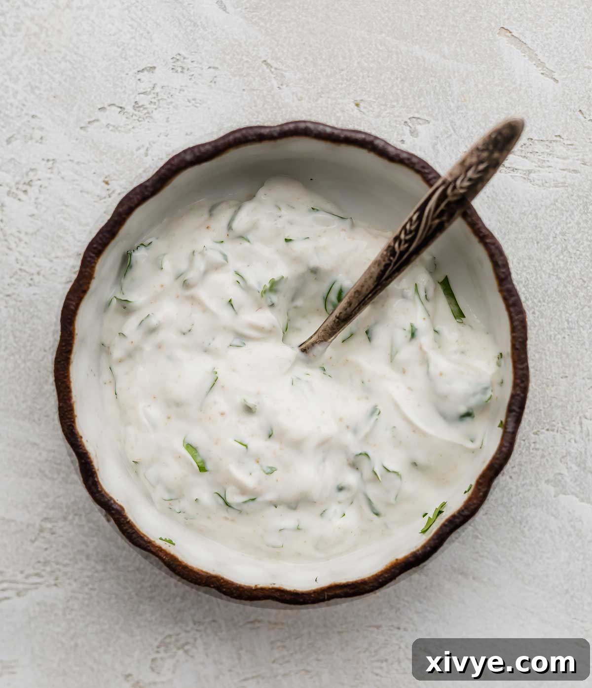 Lean and Green Chicken Wraps 4 A cilantro lime greek yogurt mixture in a black rimmed white bowl.