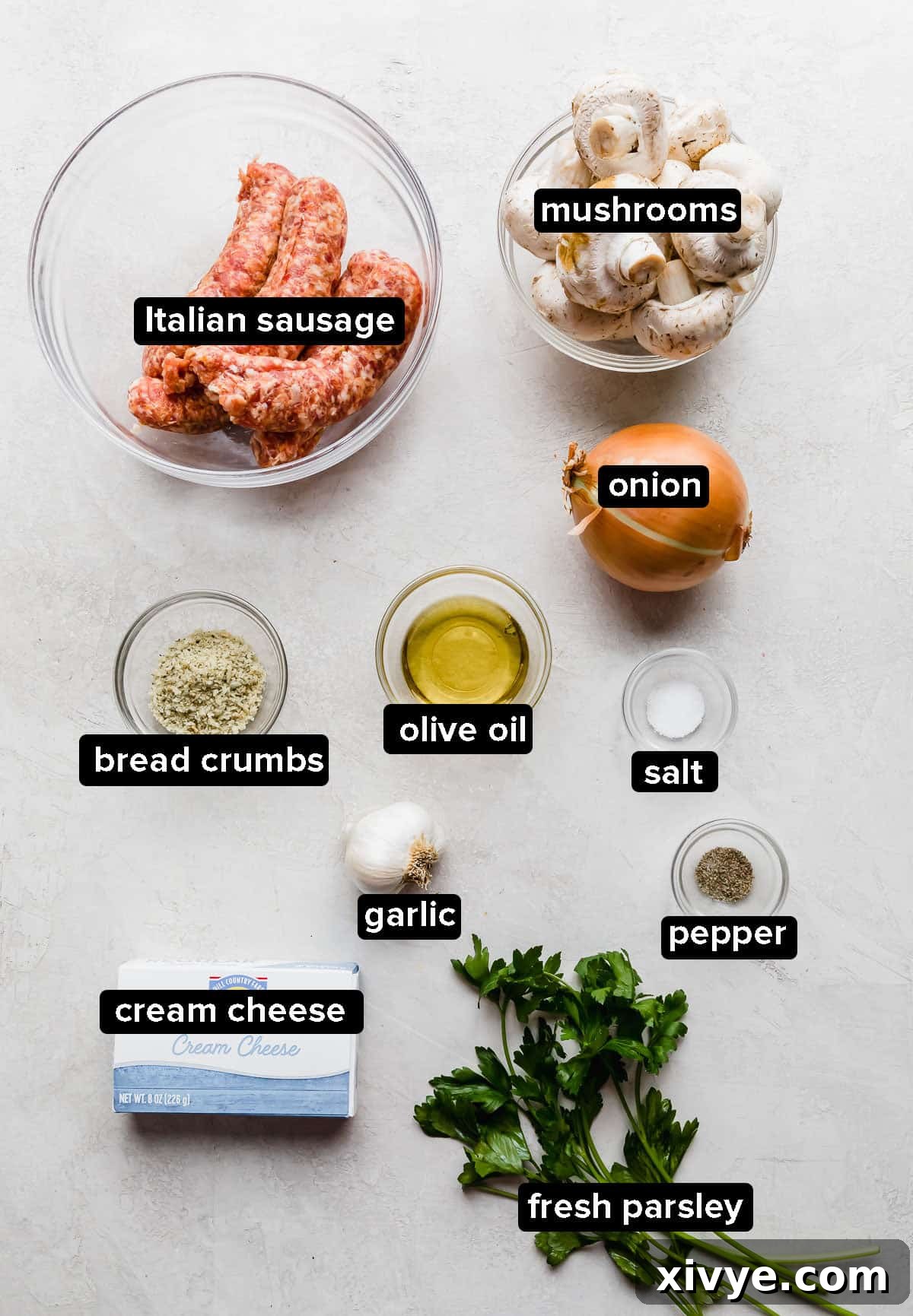 Zesty Italian Sausage Stuffed Mushrooms 3 Italian Sausage Stuffed Mushrooms ingredients laid out on a gray background.