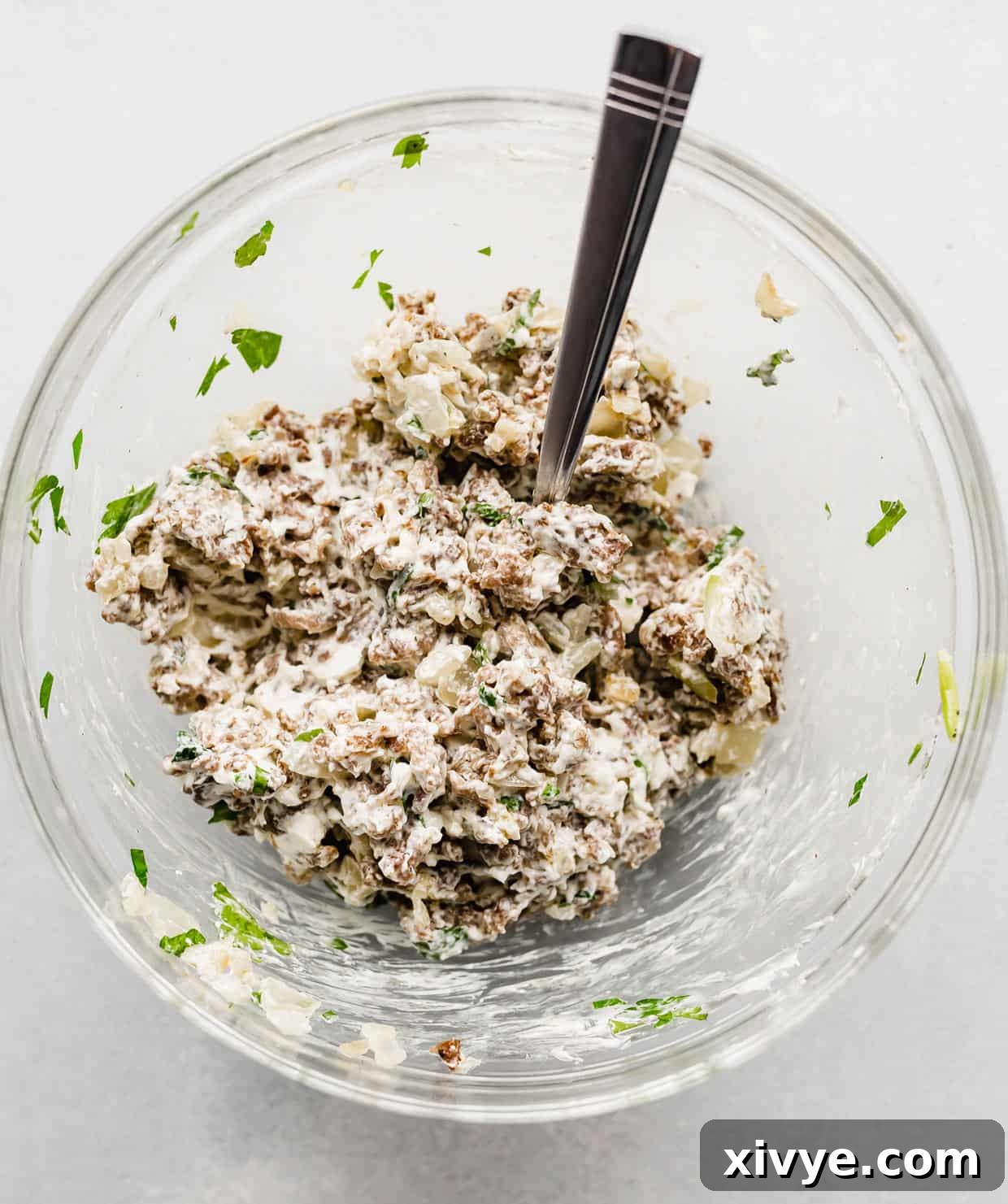 Zesty Italian Sausage Stuffed Mushrooms 5 A sausage mixture in a glass bowl for making Italian Sausage Stuffed Mushrooms.