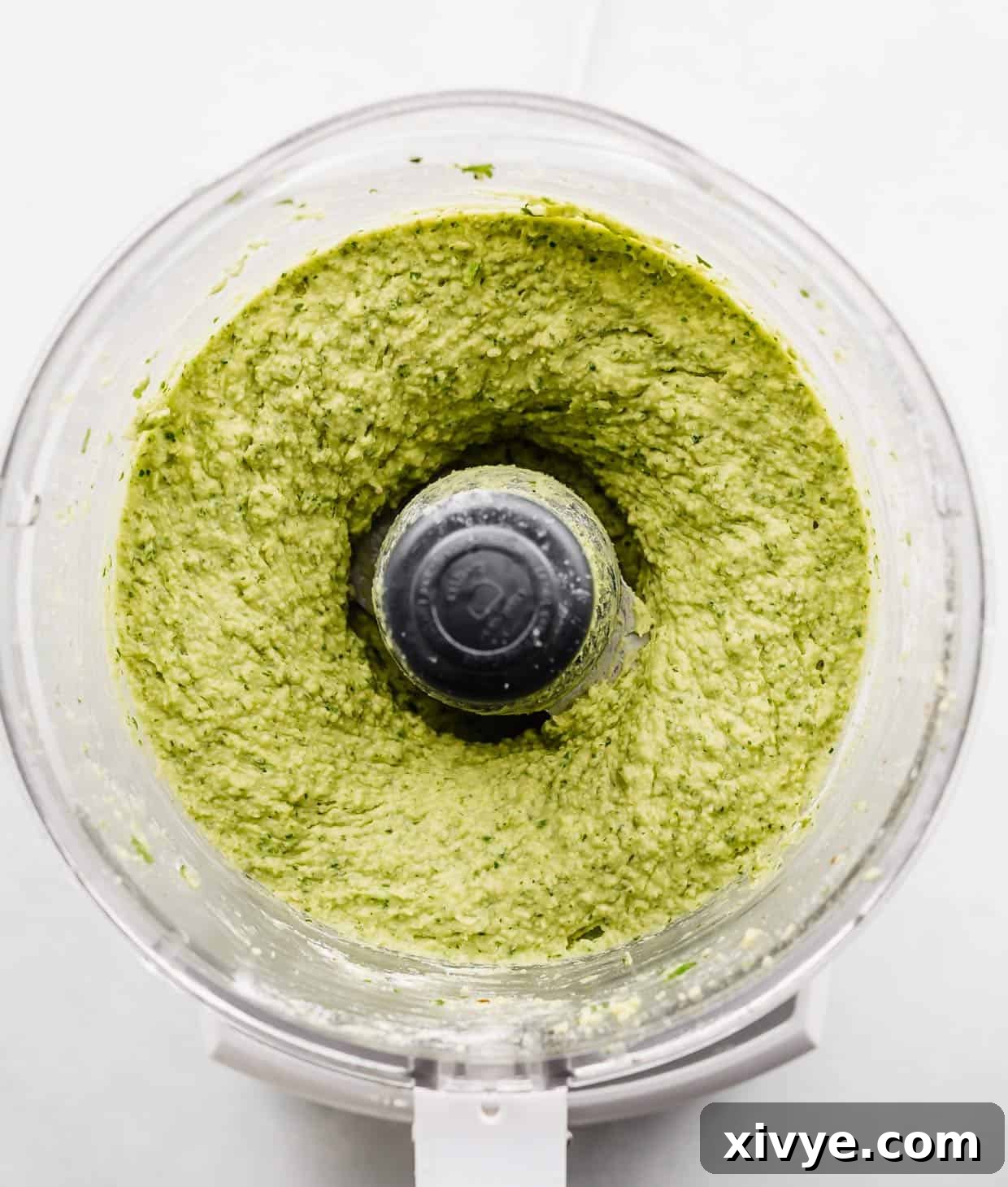 Pureed green falafel mixture in a food processor.